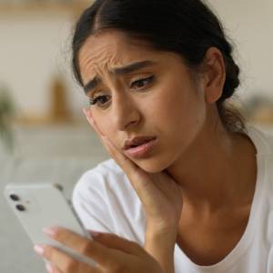 Woman looking confused on phone