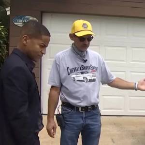 Man and news anchor in front of car