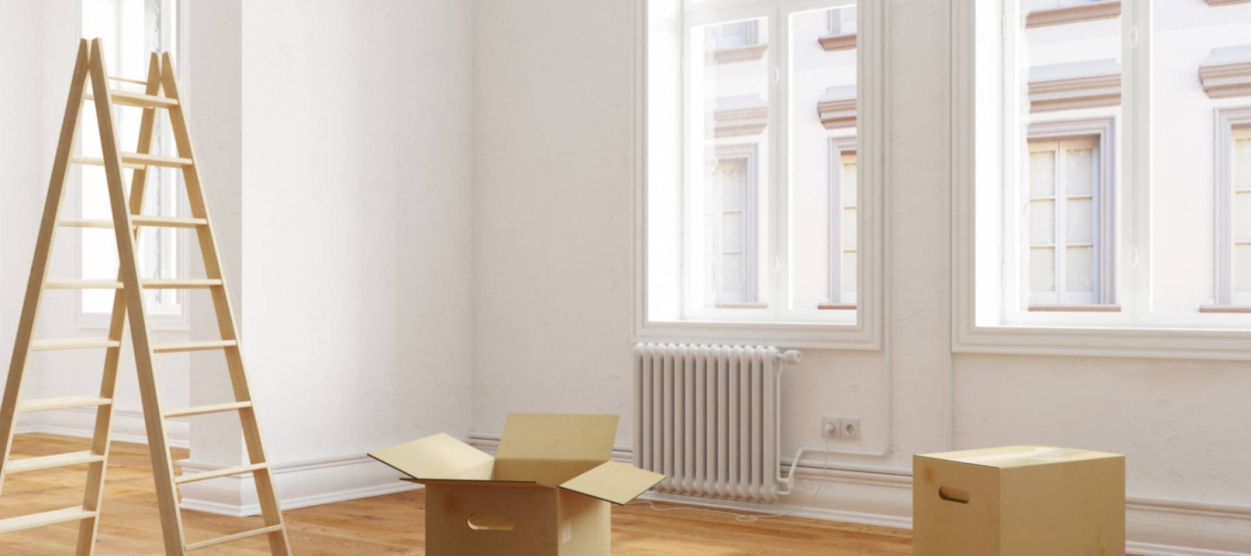 Ladder and moving boxes in empty room