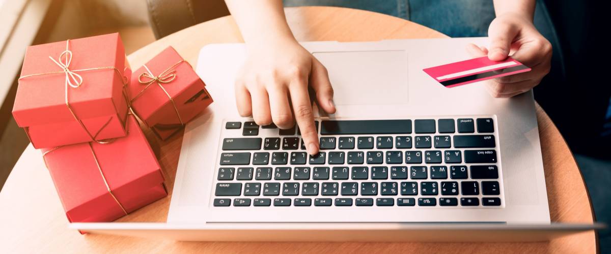 Top view of woman hand holding credit card and shopping online