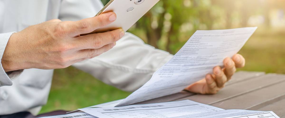 Person reviewing bills, and paying them off