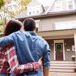 Rear View Of Loving Couple Looking At House