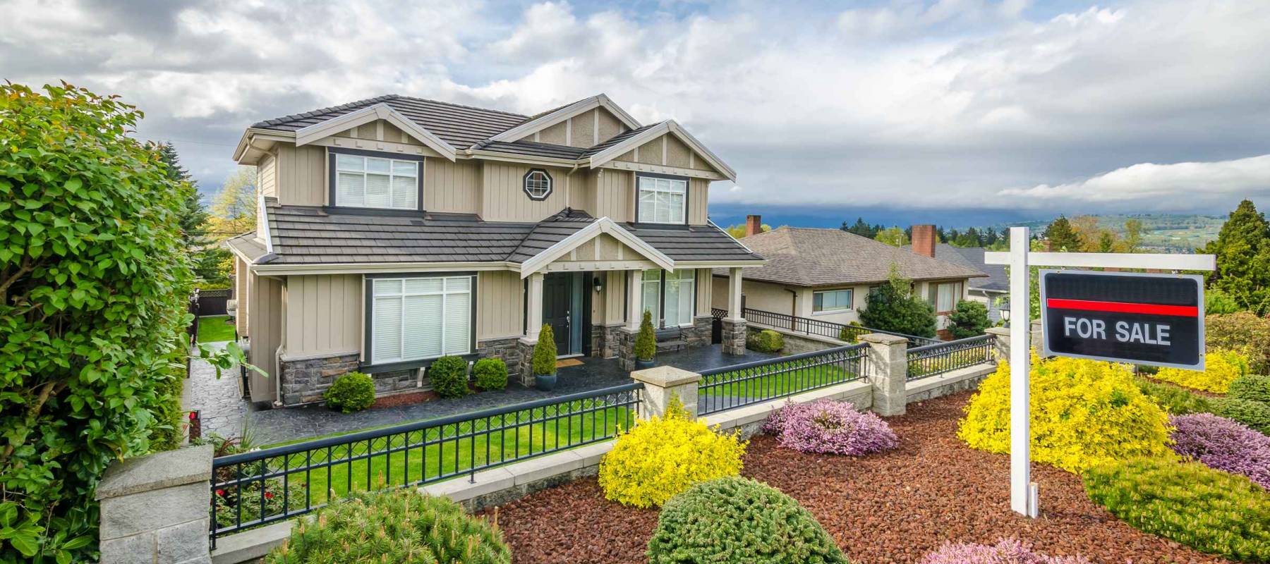 House For Sale Real Estate Sign in Front of a House.