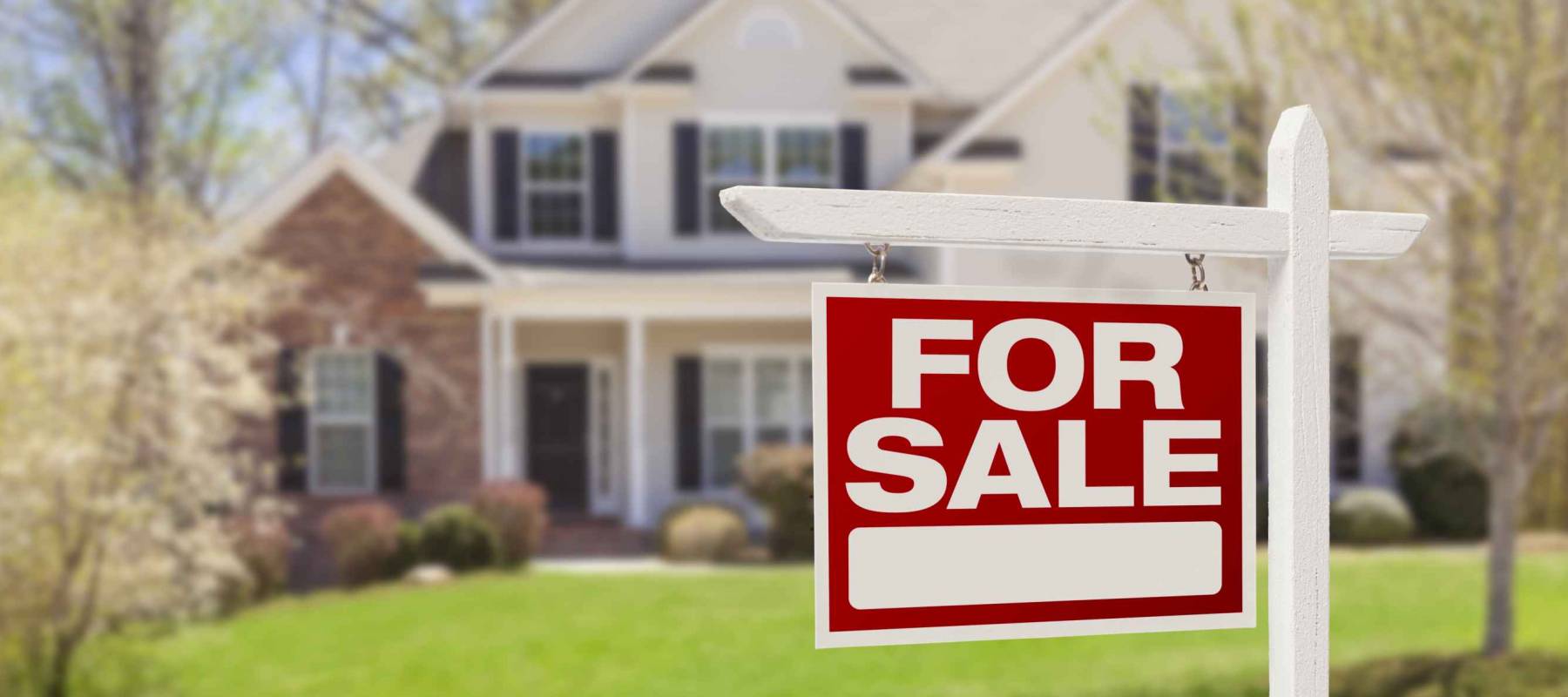 Home for sale with real estate sign