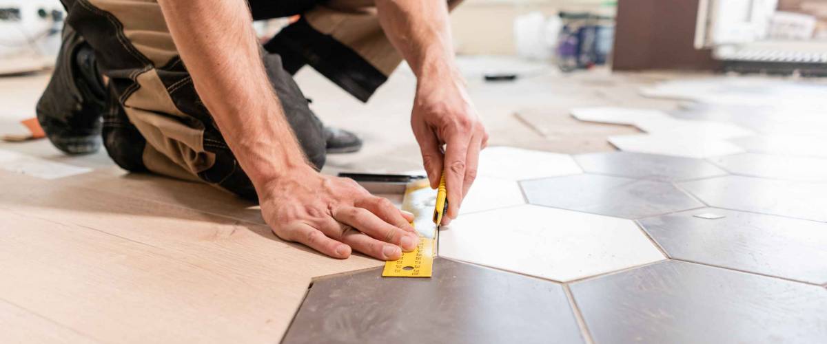 Contractor sets floor tiles