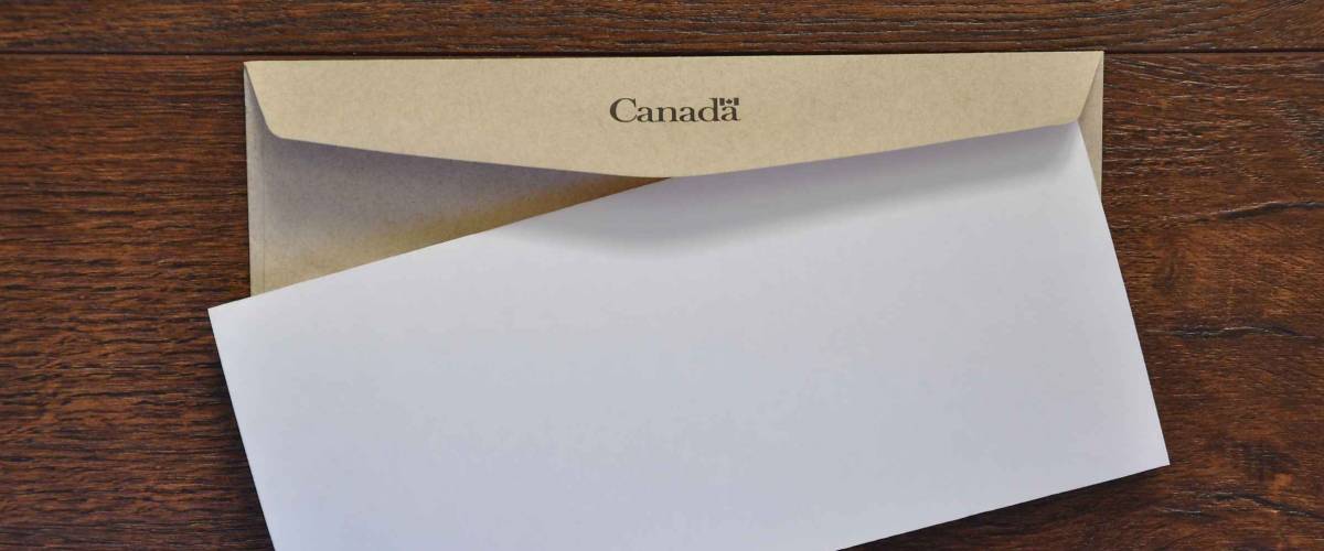 Envelope with Canada written in it and white folded paper
