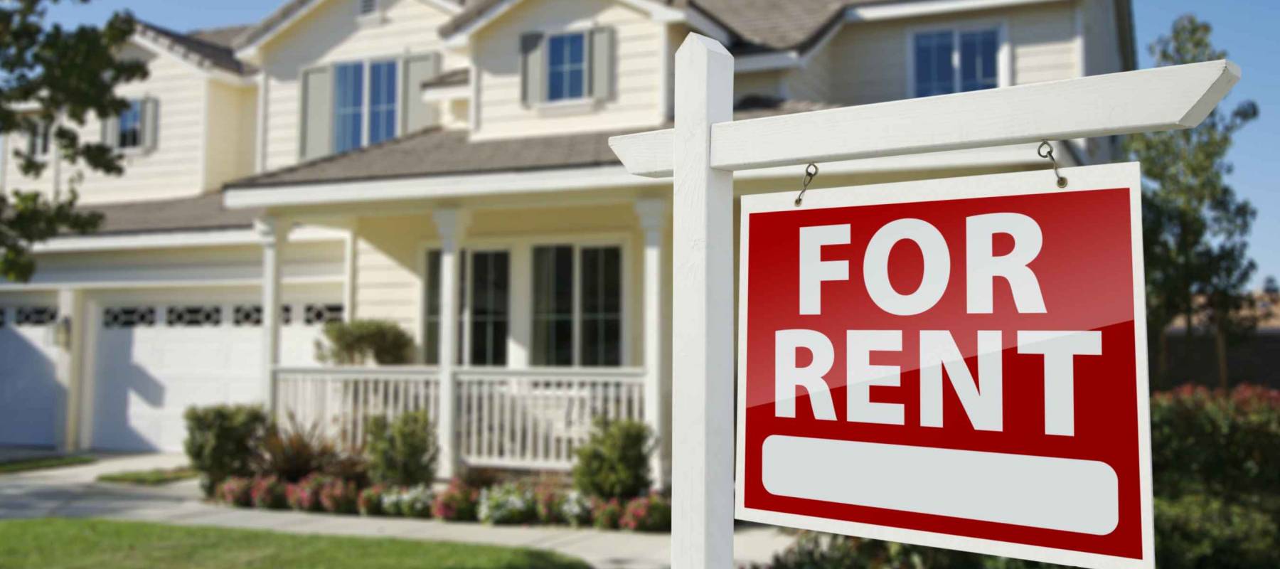 Left Facing Red For Rent Real Estate Sign in Front of Beautiful House.