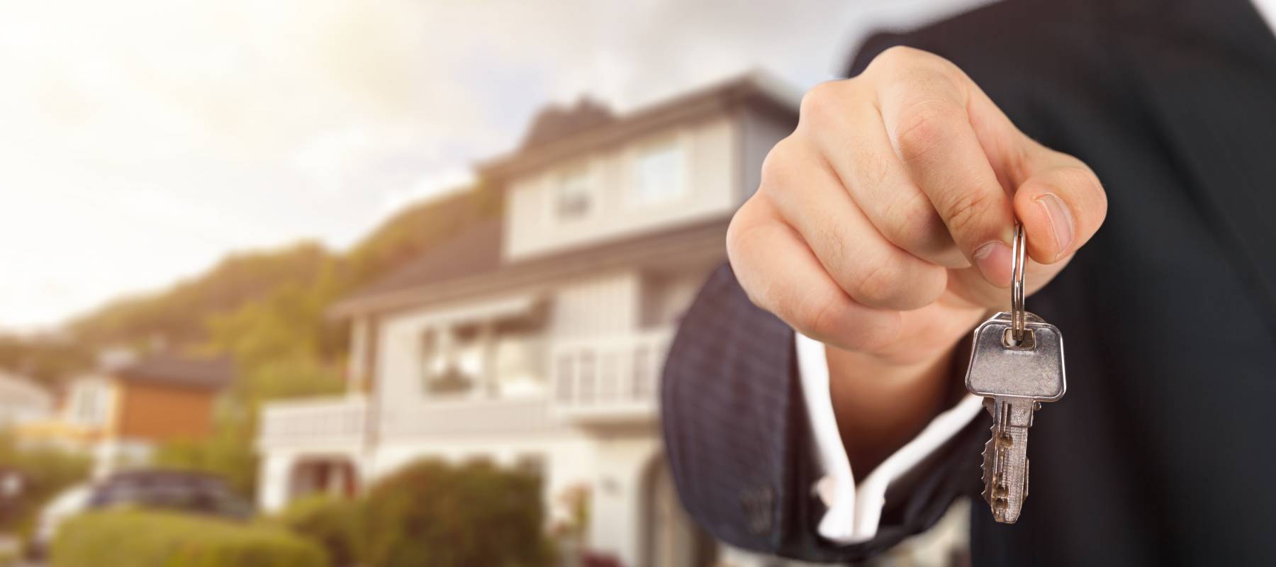 Hand holding, dangling home key