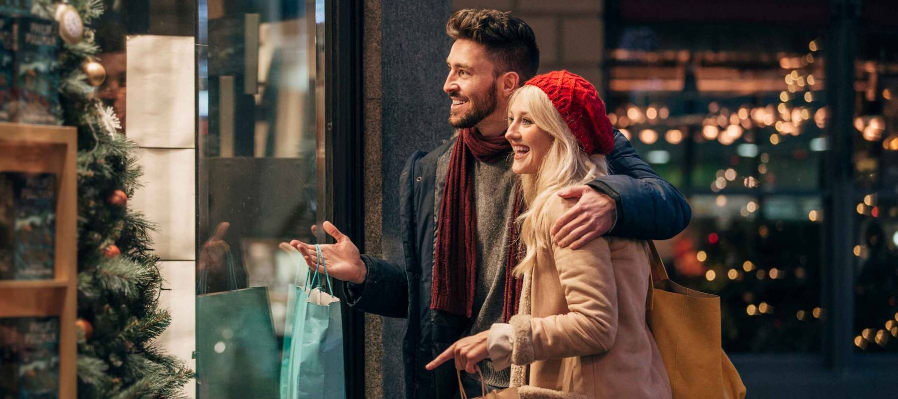 Side view of a couple doing some window shopping at christmas.