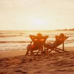 Retired couple walking on the beach.