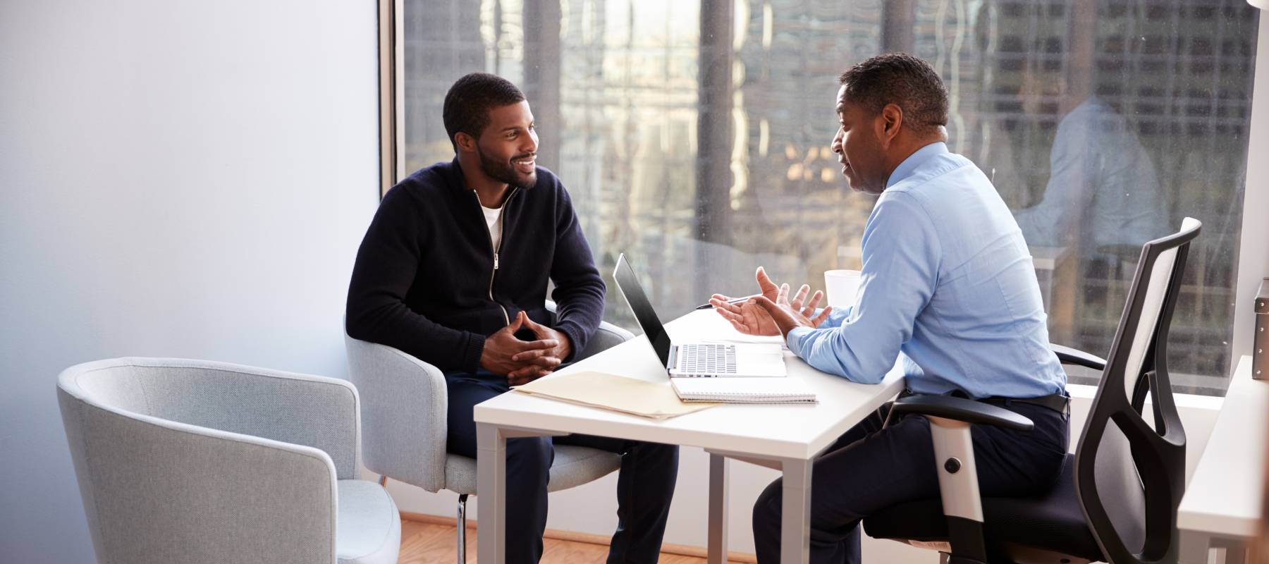 Smiling man meeting with financial advisor