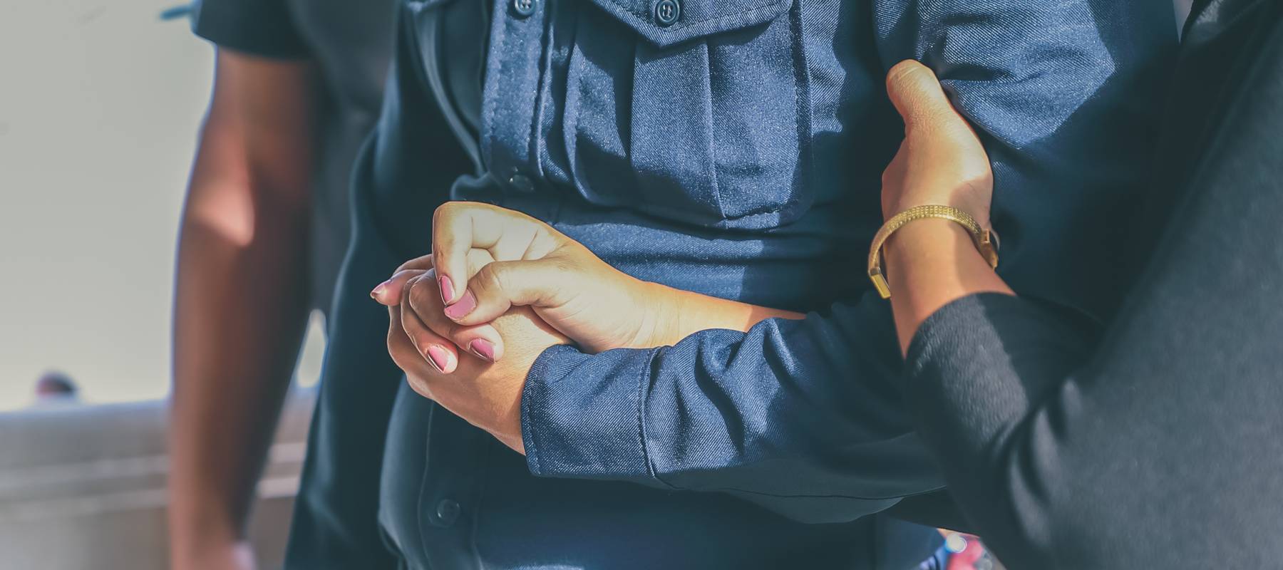 People holding hands at a funeral