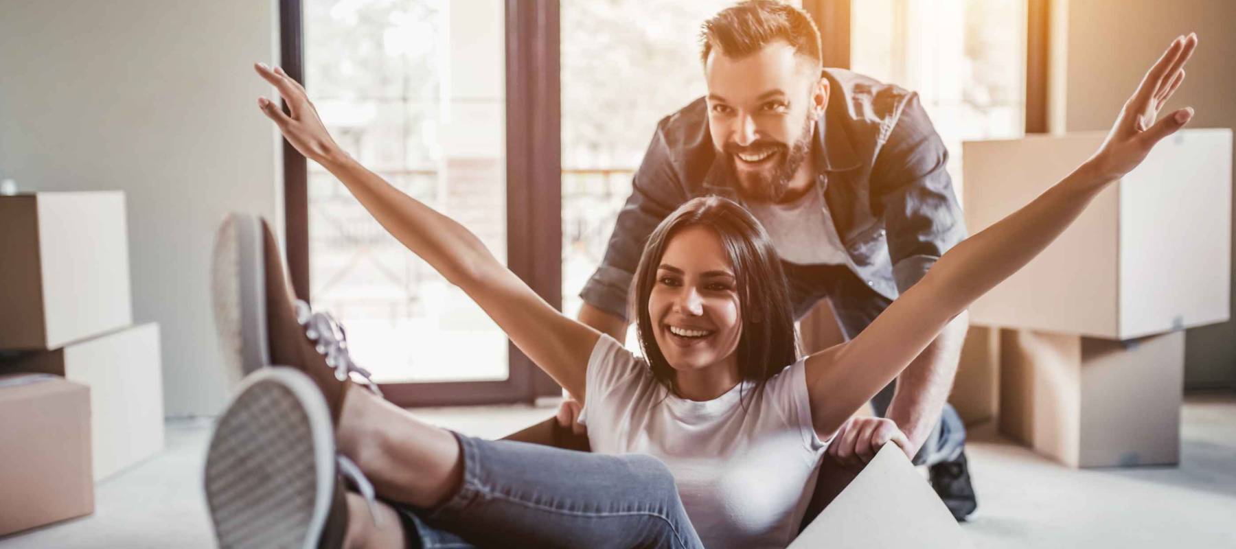 young Caucasian couple with moving boxes