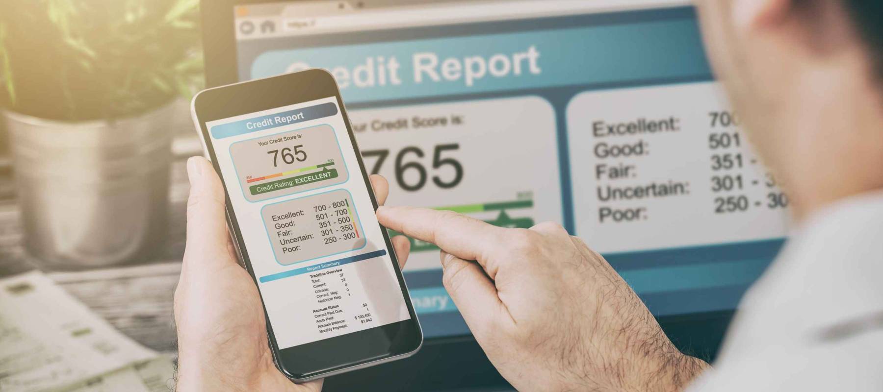 Caucasian man with cellphone featuring credit score on screen