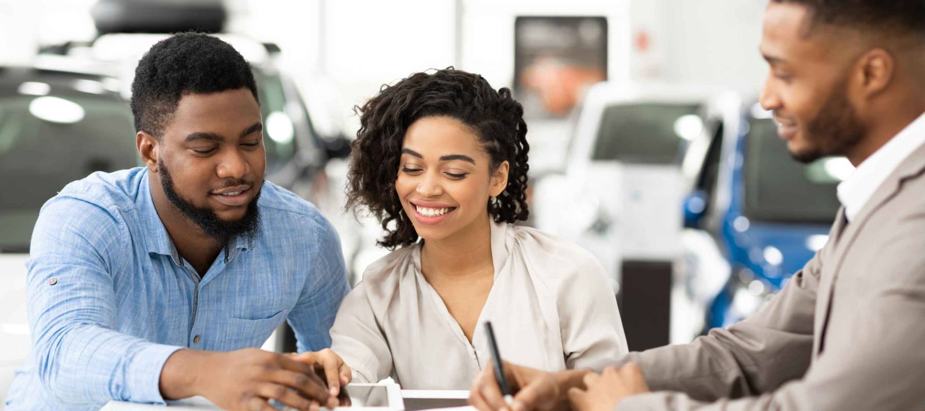 a young Black couple buying a car