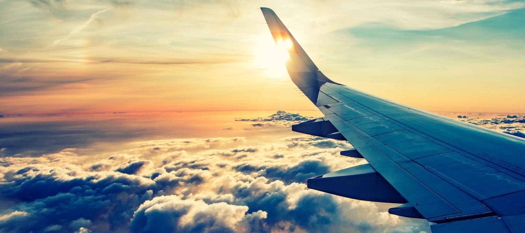 flying and traveling, view from airplane window on the wing on sunset time
