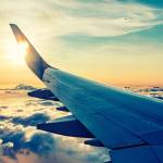 flying and traveling, view from airplane window on the wing on sunset time