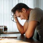 Man stressed while working on laptop