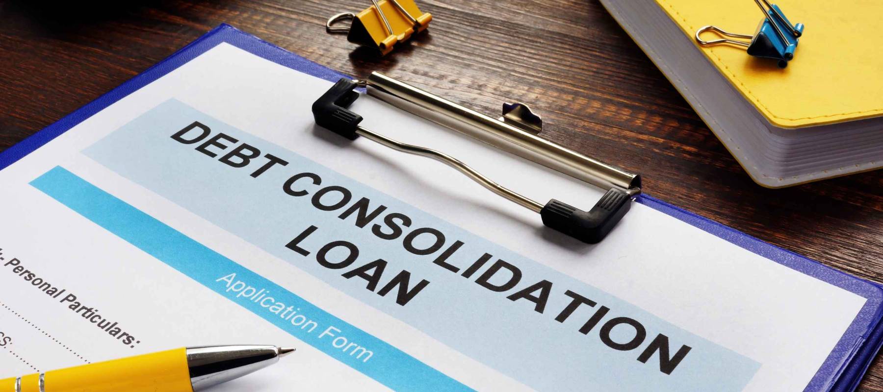 Debt consolidation loan form, notepad and calculator.