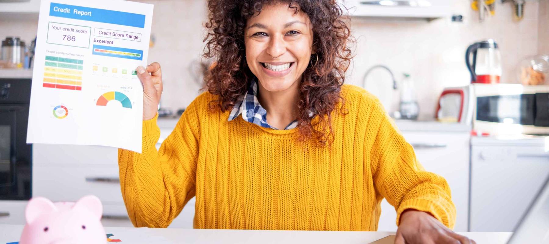Happy black woman checking her good credit score online