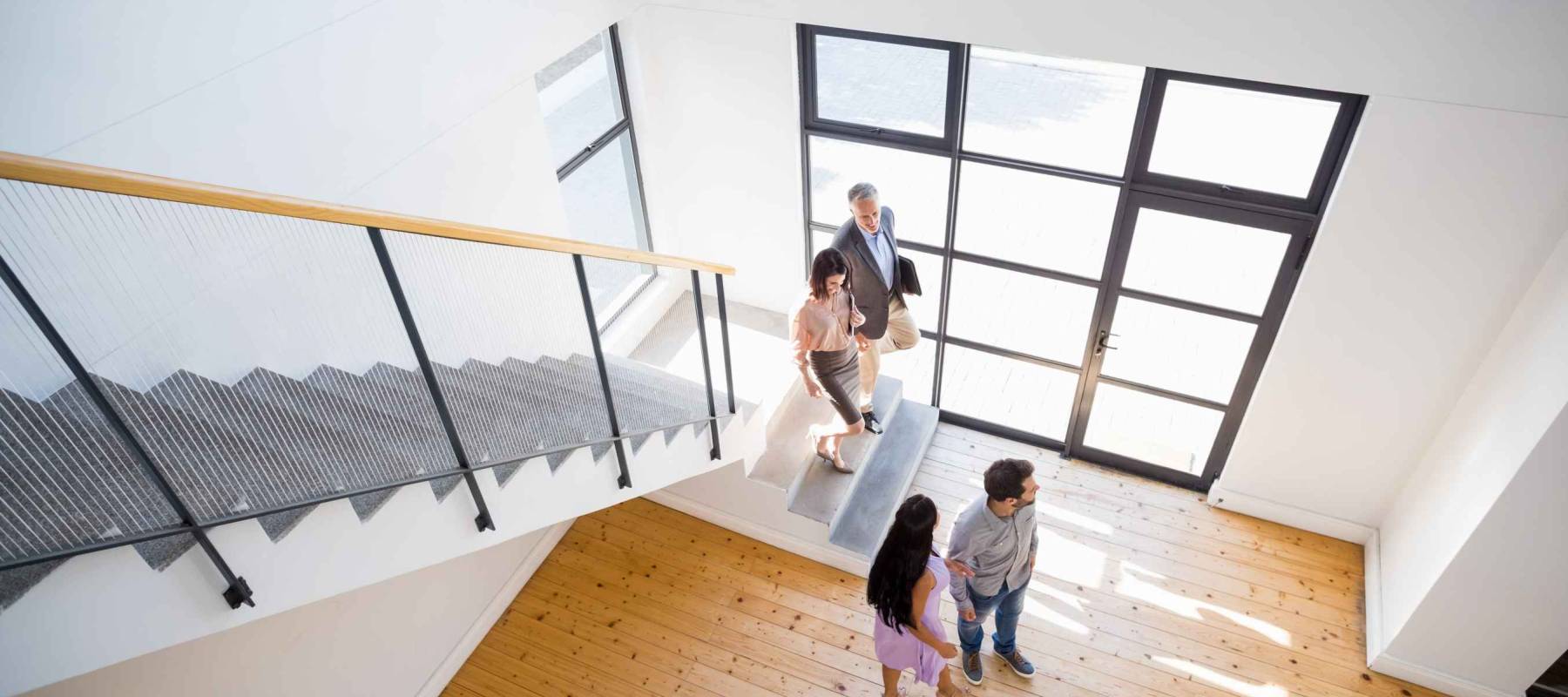 Real estate agent showing new house to couple