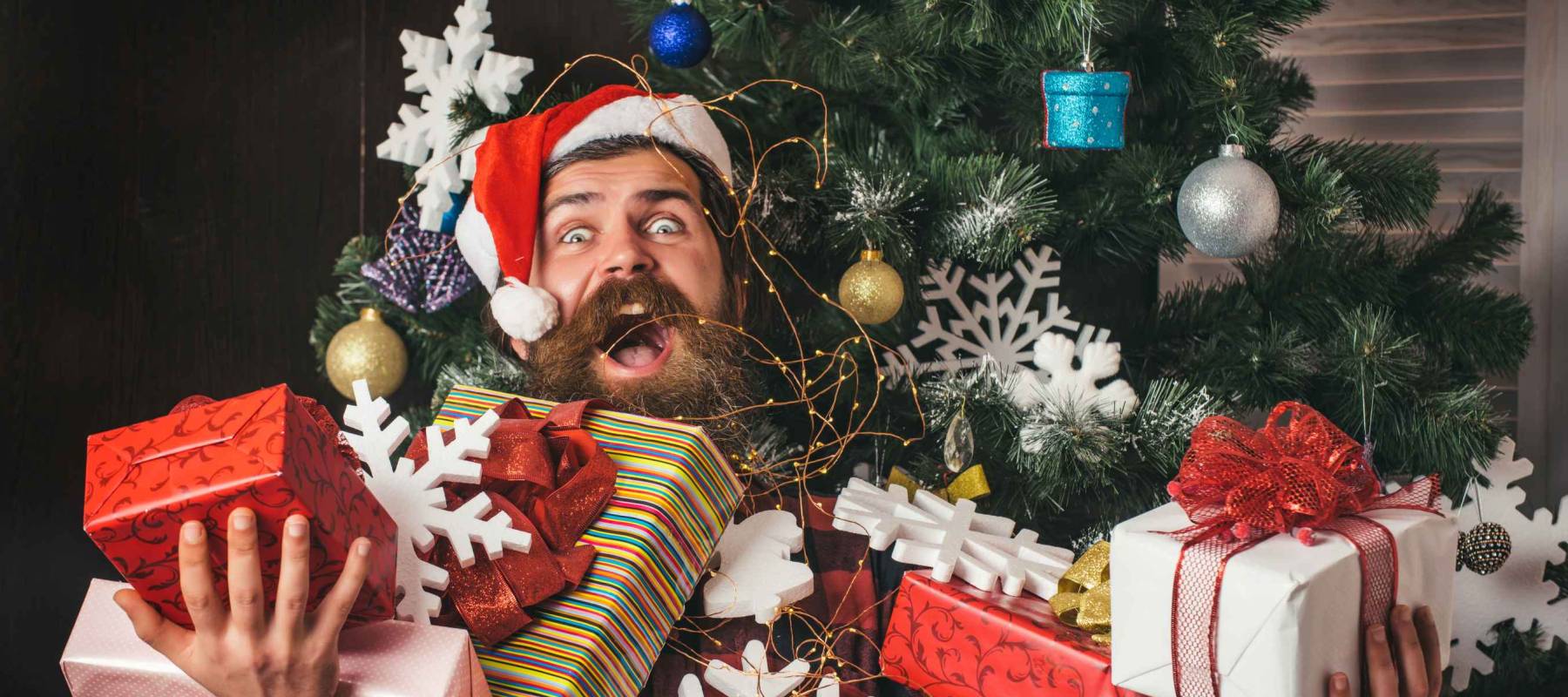 boxing day and cyber Monday\ man with present box at christmas tree. Christmas man happy face hold gift.