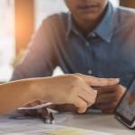 financial advisory services. Asian advisor showing plan of investment to clients in the consultancy office.