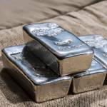 Cast silver bars against the background of the texture of. Selective focus.