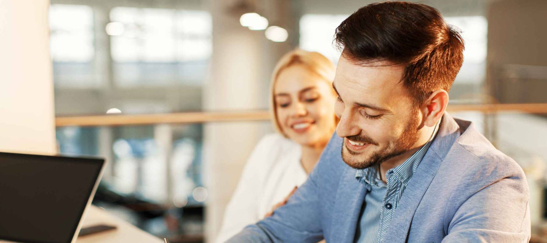Young business couple signing a contract