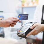 Customer using credit card for payment to owner at cafe restaurant, cashless technology and credit card payment concept