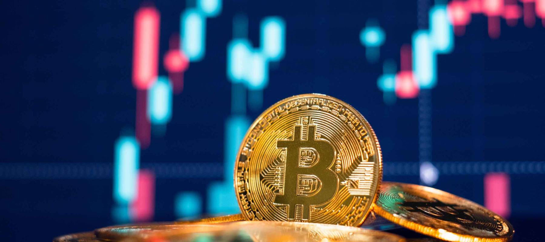 Bitcoin gold coin and defocused chart background. Virtual cryptocurrency concept.