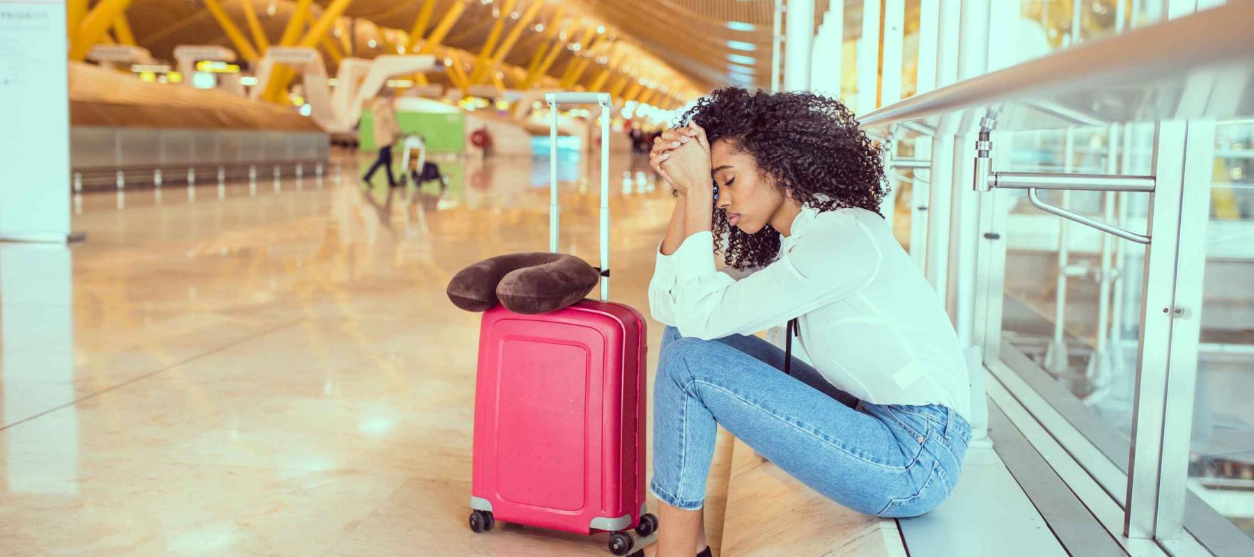 Woman sad and unhappy at the airport with flight canceled