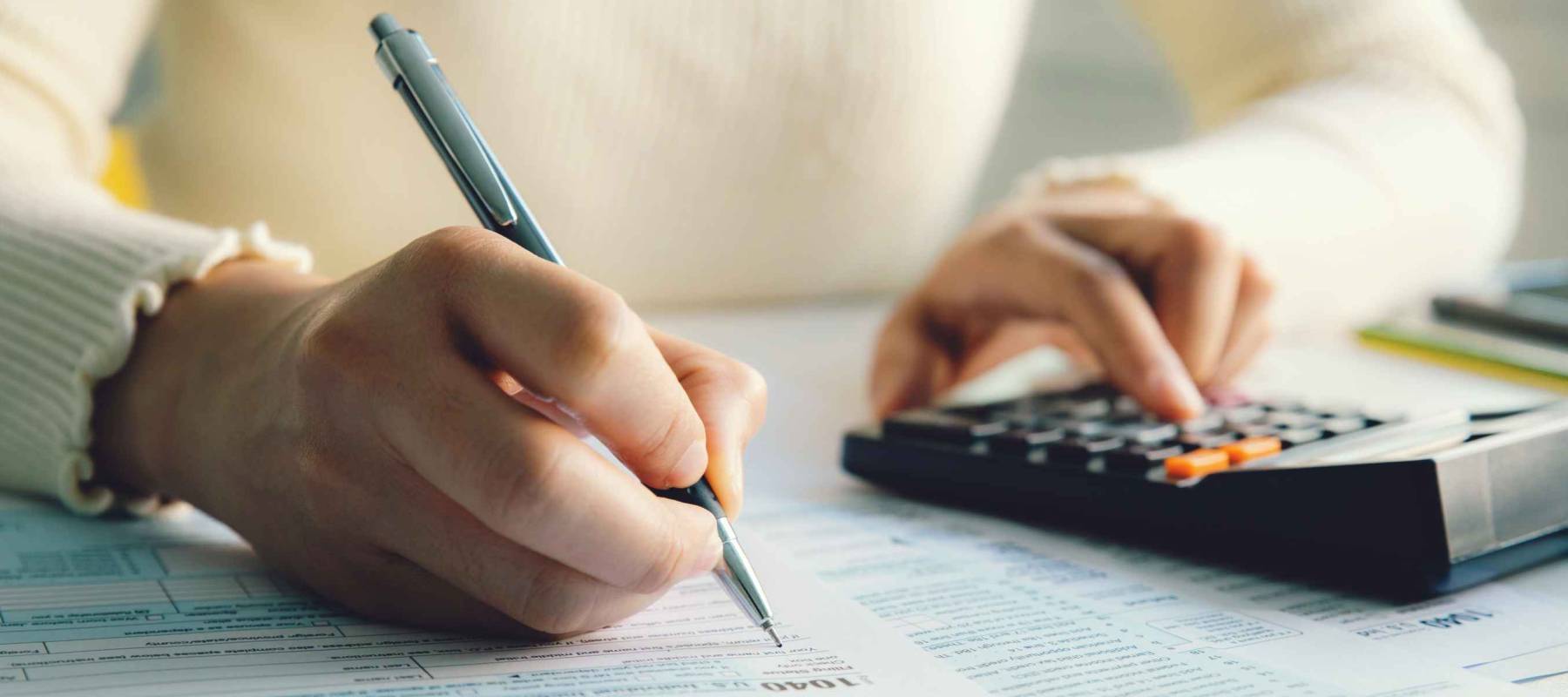 Closeup woman filling form of Individual Income Tax Return,