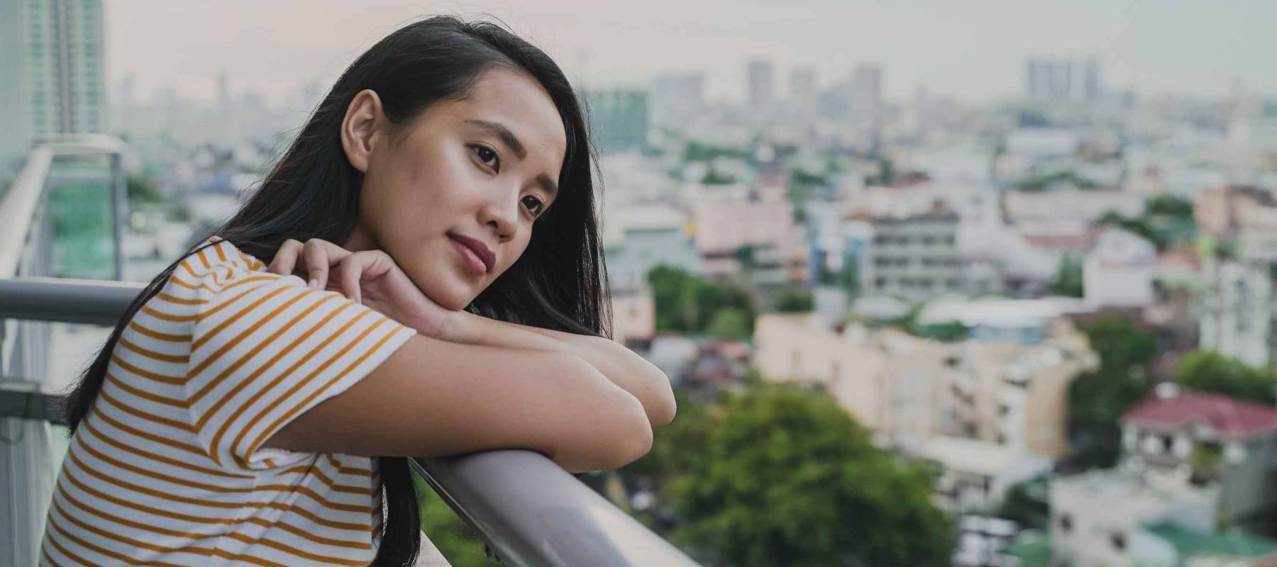 Asian Woman in Quarantine Reflecting on Condo Balcony