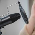 Using condenser mic for making podcast, Close up.