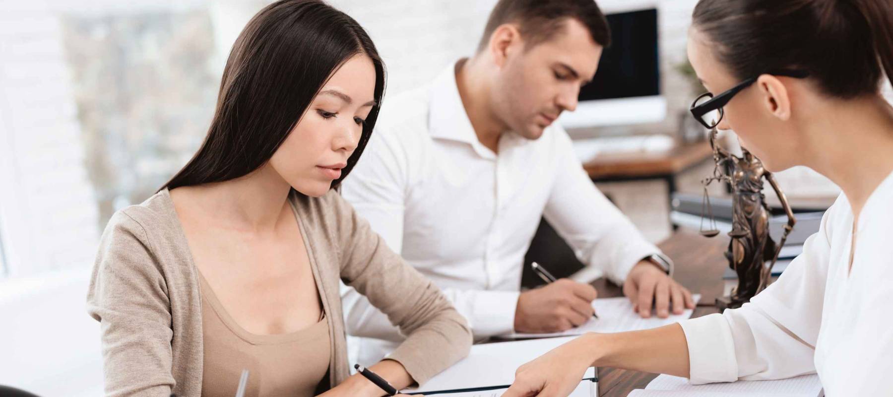 The couple went to a lawyer to conclude an agreement on the divorce. They quarrel and argue with each other. Lawyer prepares documents.