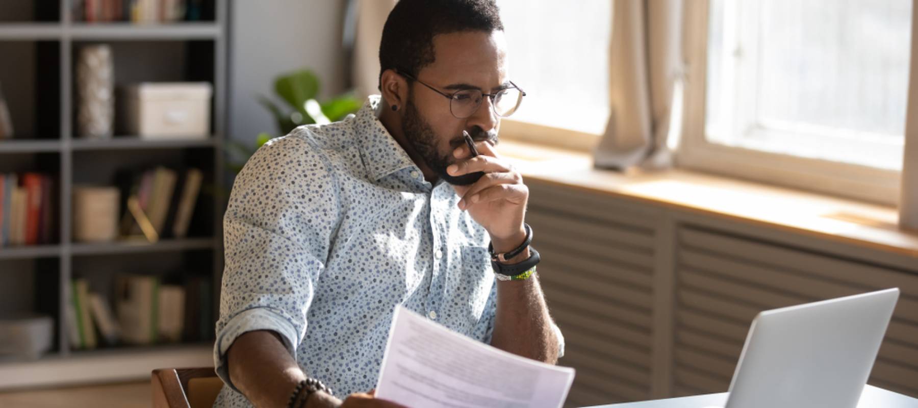 Man focused on computer and paperwork