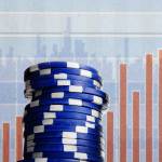 Blue poker chips on stock market chart background