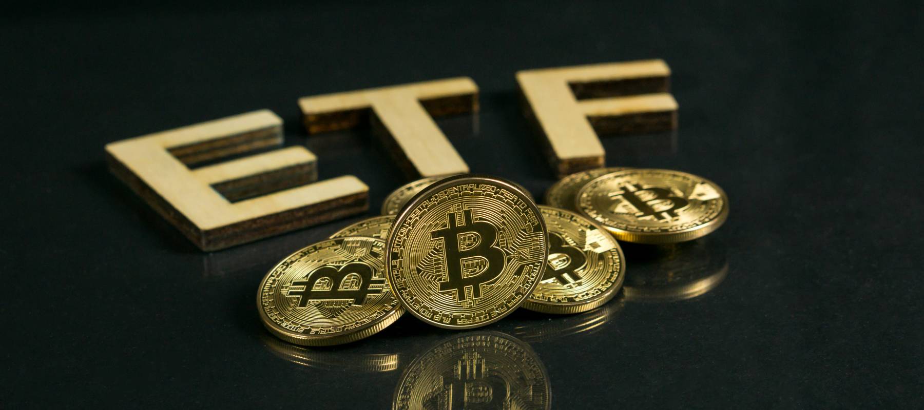 Bitcoin coin with ETF text Put on wooden floor, Concept Entering the Digital Money Fund.