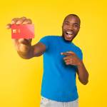 Male holding credit card and looking excited