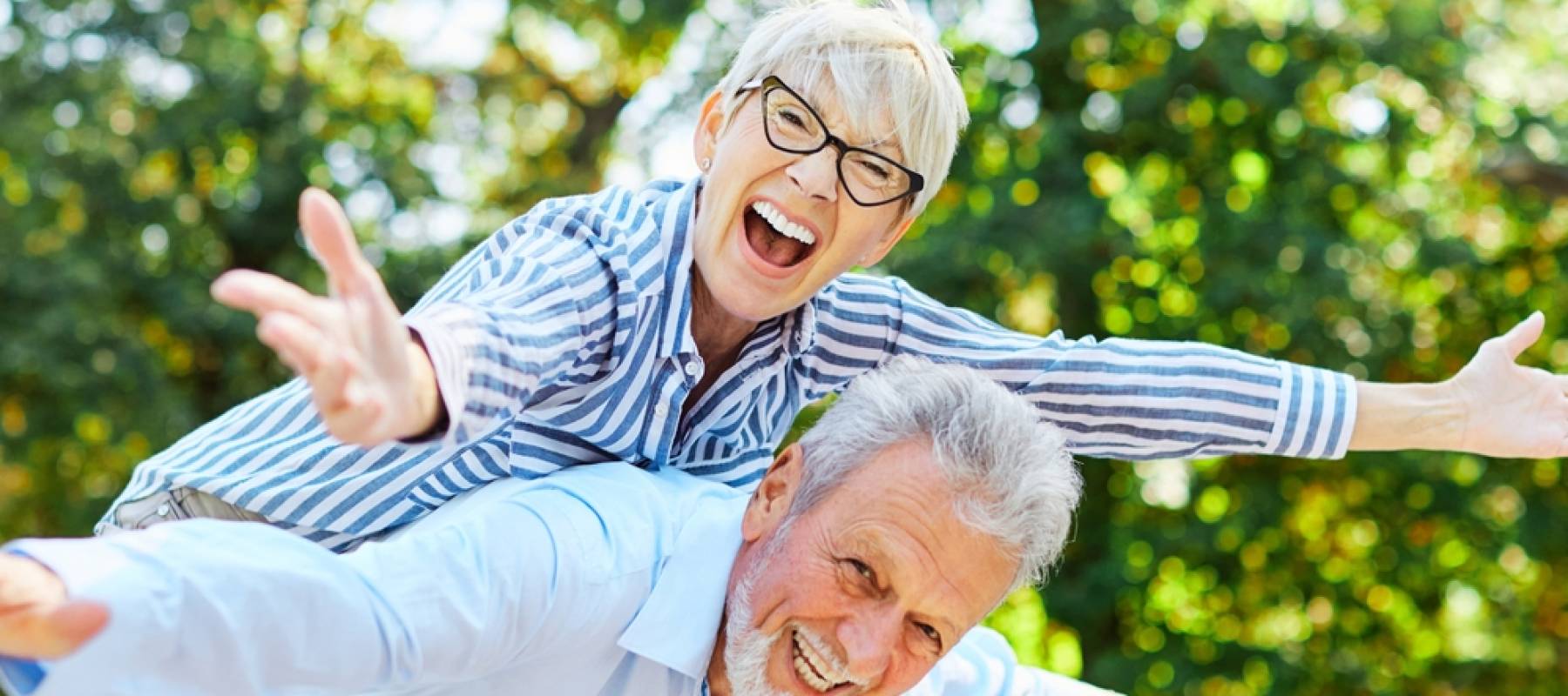 Happy active senior couple having fun outdoors.