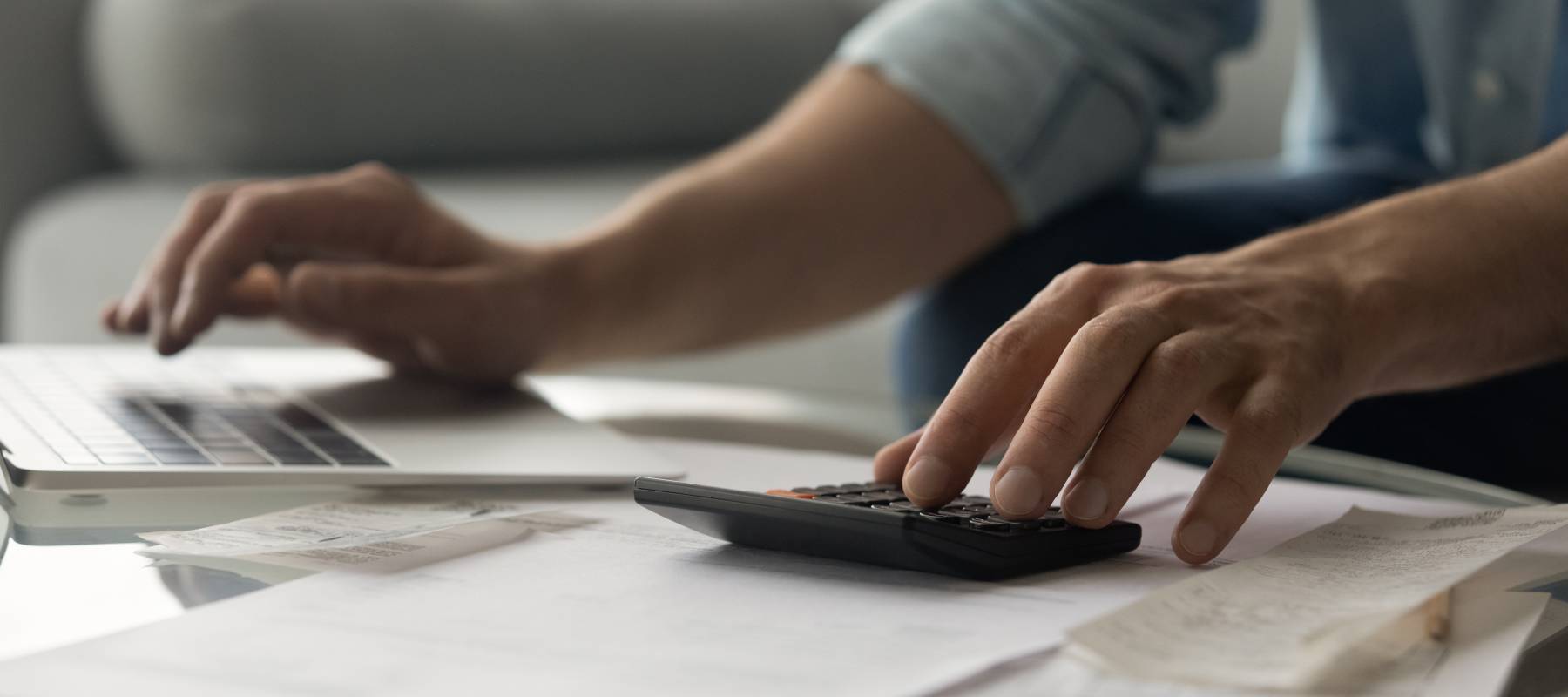 Close up on man's hands doing calculations