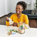 Woman sitting on table holding banknotes
