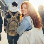 Female student glancing back while going for a class in college.