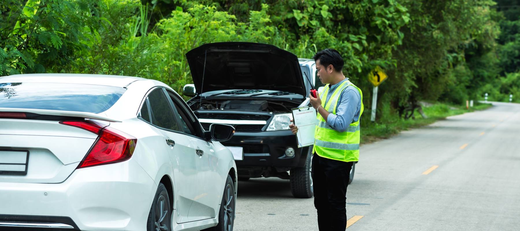 Auto insurance agent inspecting vehicles after accident