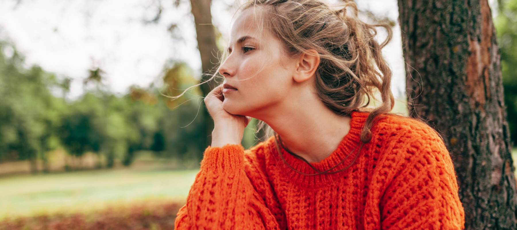 Young woman contemplating outside