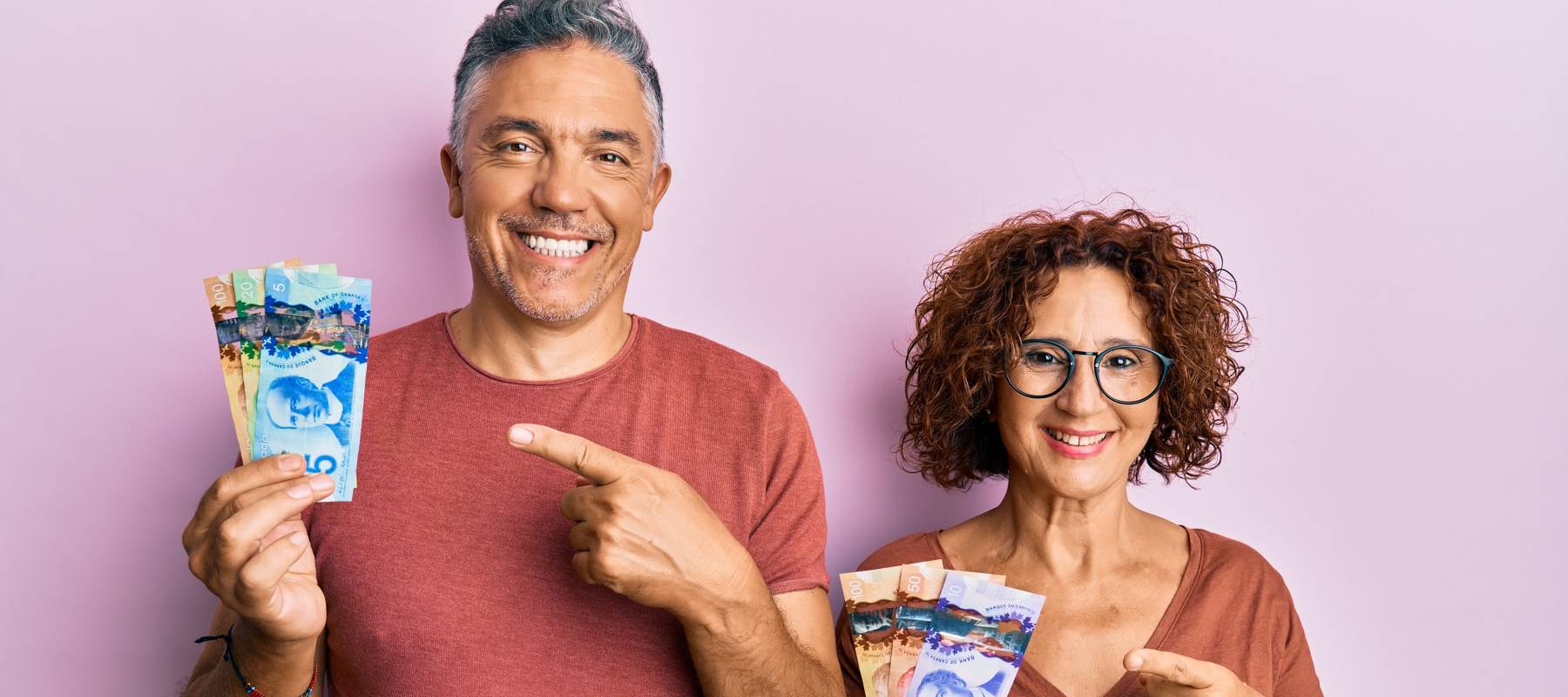 Happy couple holding up cash