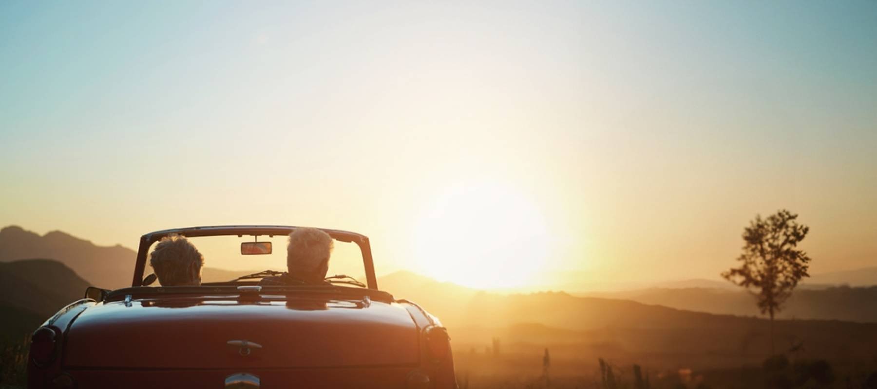 retired couple driving off into the sunset