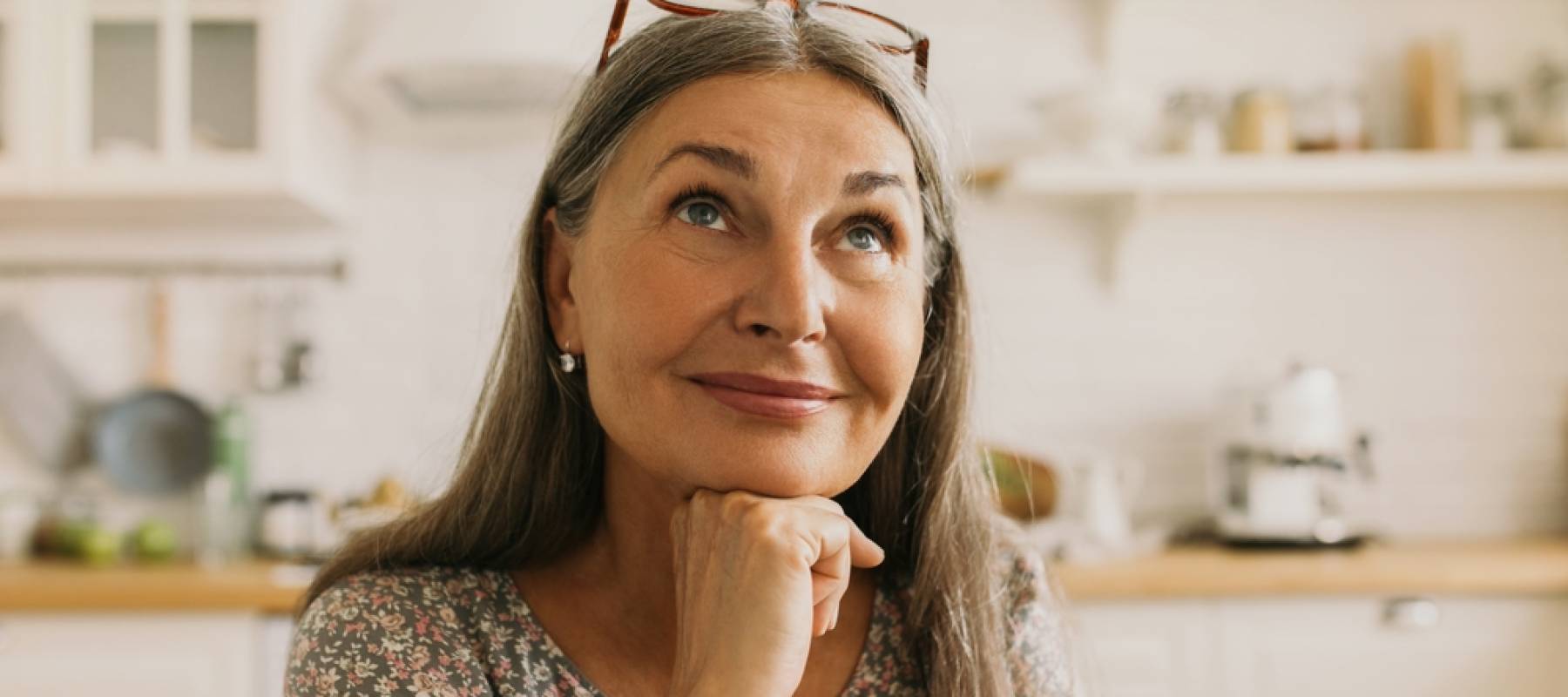 Older woman sitting down pondering