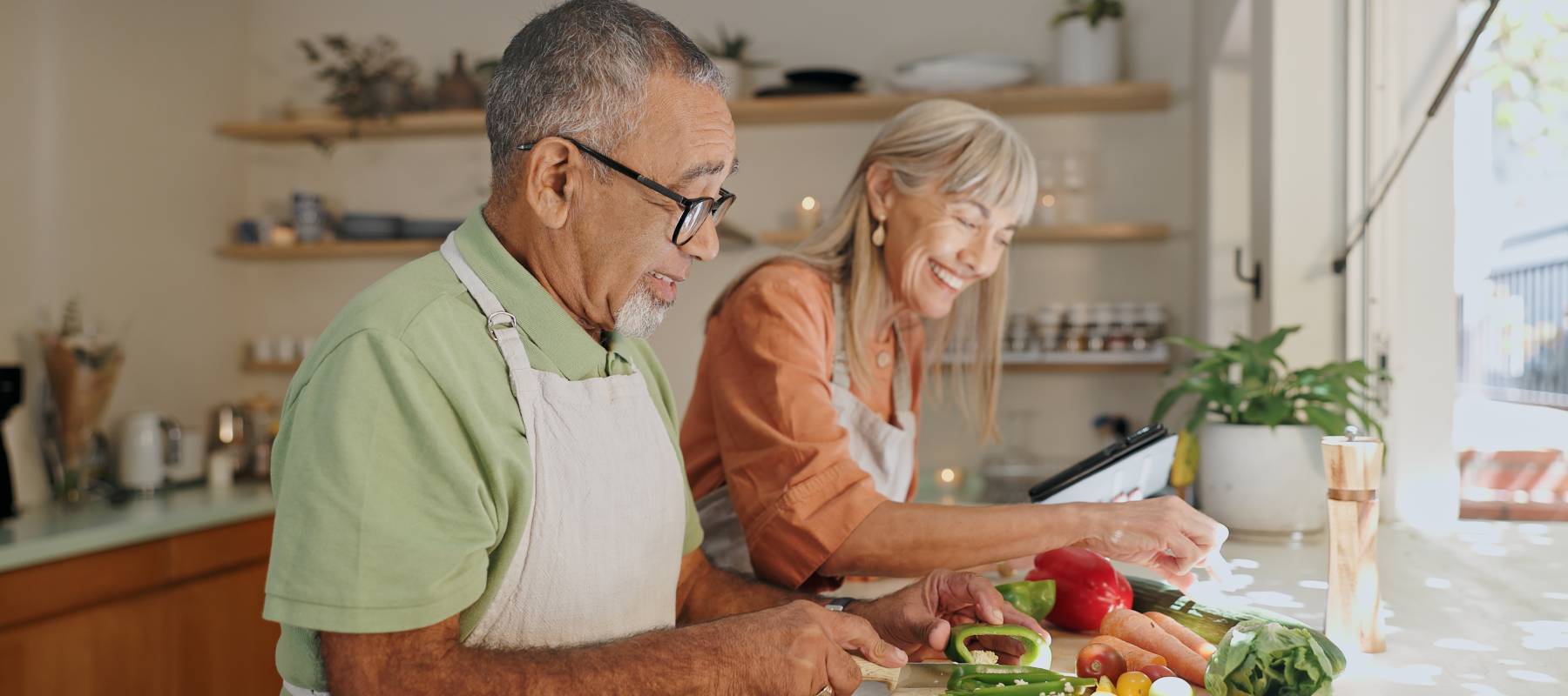 Elderly couple cooking a healthy dinner